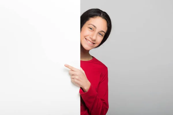 Teenager student showing a blank panel — Stock Photo, Image