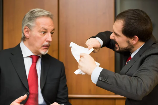 Angry businessman tearing up document — Stock Photo, Image