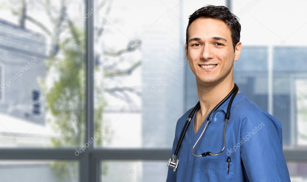 Male nurse smiling in hospital  