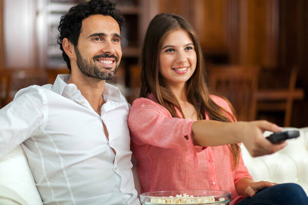 couple watching tv and eating pop-corn