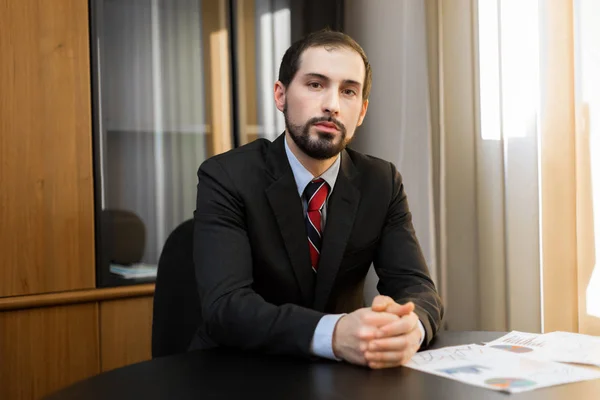 Businessman sitting in office — Stock Photo, Image