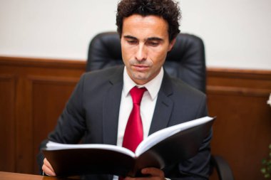 İşadamı ofisinde bir kitap okuma