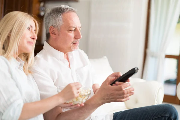Couple watching a movie in their house