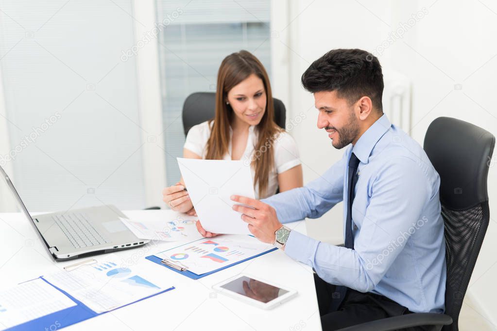 Two young business people at work in their office