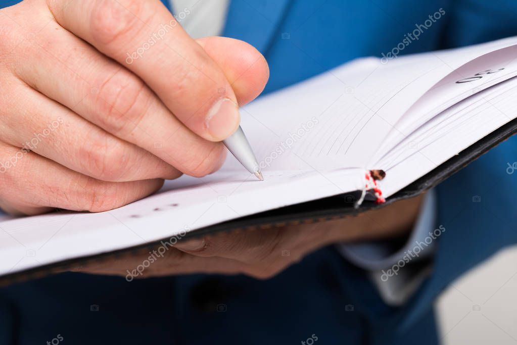 Detail of a businessman taking notes