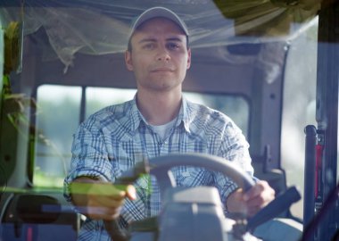 Gülümseyen çiftçi bir traktör sürüş