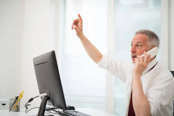 Empresário Falando Telefone Levantando Braço Enquanto Usa Seu Computador — Fotografia de Stock