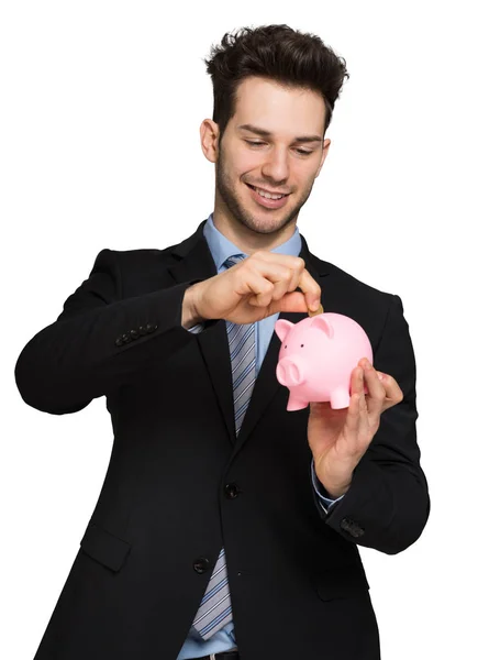 Smiling Young Businessman Putting Money Piggy Bank — Stock Photo, Image