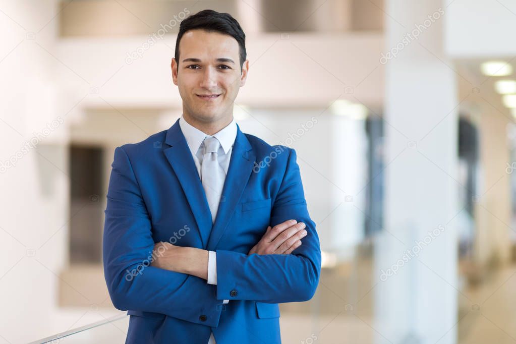 Portrait of a smiling businessman crossed arms 