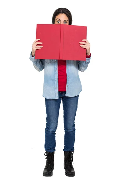 Girl looking from behind a book — Stock Photo, Image