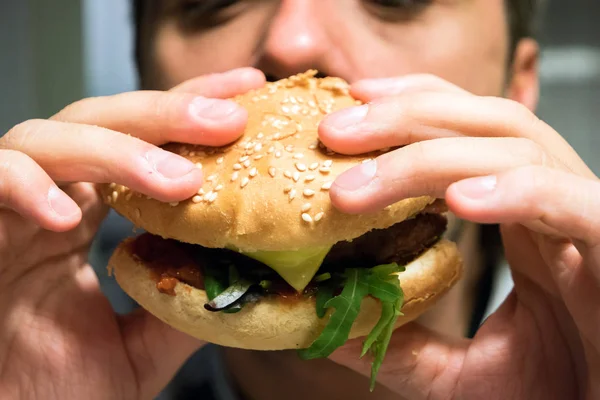 Man eating an hamburger in a fast food