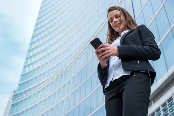 Smiling Young Business Woman Using Her Mobile Cell Phone Stock Photo