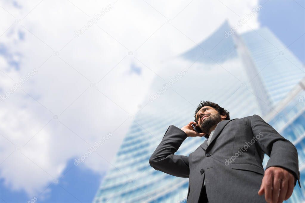 Portrait of a confident businessman in front of a modern building
