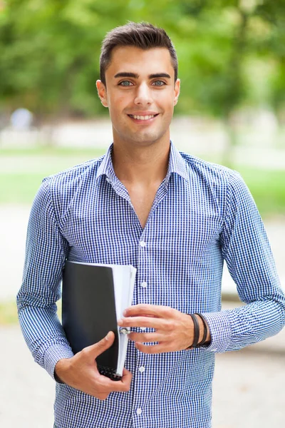 Smiling student outdoor in a college courtyard — Stock Photo, Image