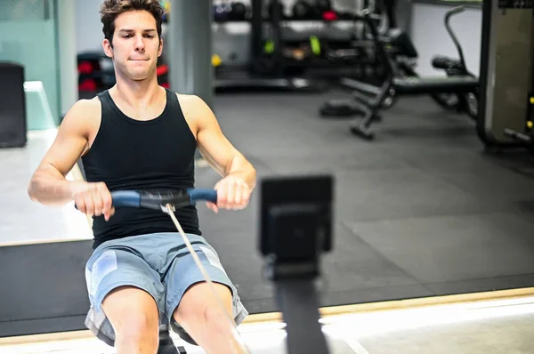 Joven Haciendo Ejercicio Máquina Remo Entrenamiento Concepto Fitness —  Fotos de Stock