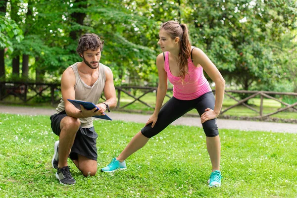 Smiling Man Showing Training Table Woman Stretching Personal Training Fitness — Stock Photo, Image