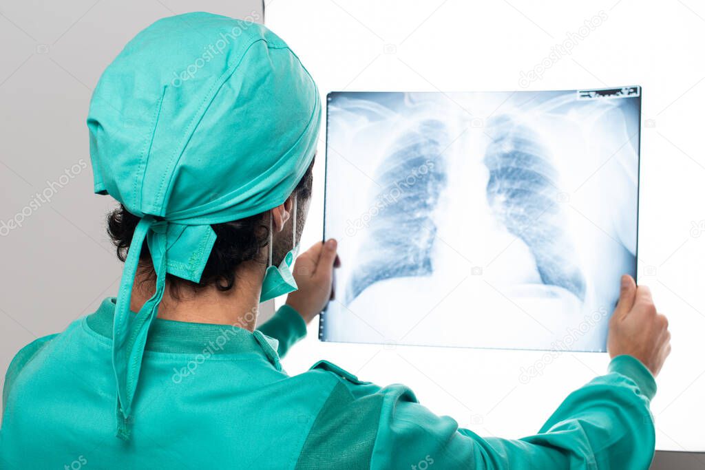 Surgeon analyzing a lung radiography