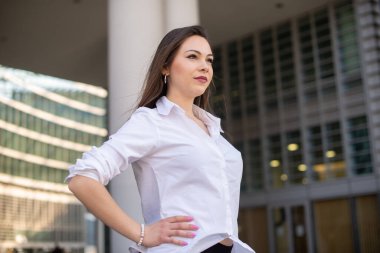 Portrait of a young woman walking in a modern city