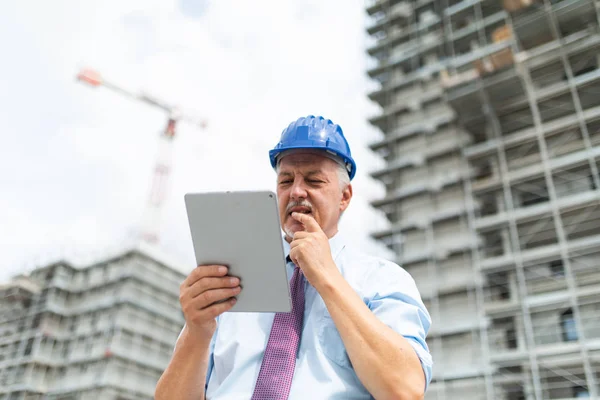 Site Manager Using His Digital Tablet Front Construction Site — Stok fotoğraf