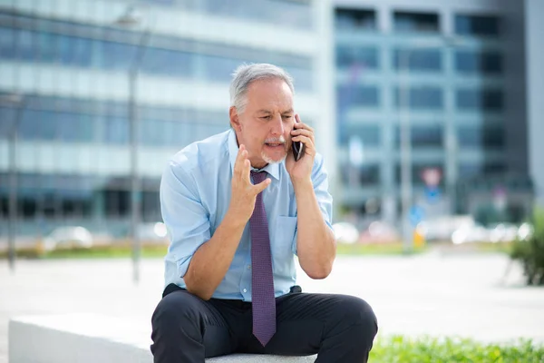 Irritated Businessman Talking Cellphone — 图库照片