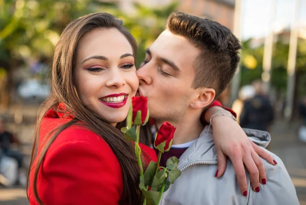 Young Man Giving Flowers Kissing His Girlfriend — Stok fotoğraf