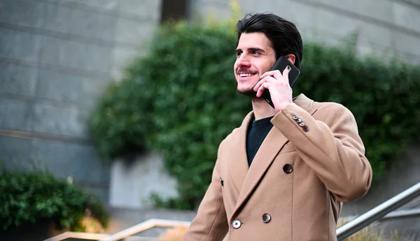 Handsome elegant dressed man talking on the phone