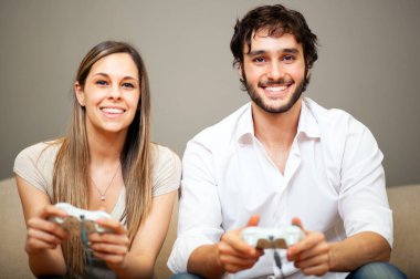 Young couple playing video games clipart