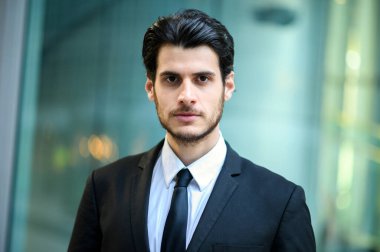 Genç iş adamı açık havada ciddi bir ifadeyle