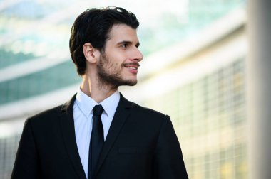 Genç işadamı kendinden emin bir şekilde gülümsüyor