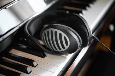 Dijital piyanonun üzerinde duran kulaklık.