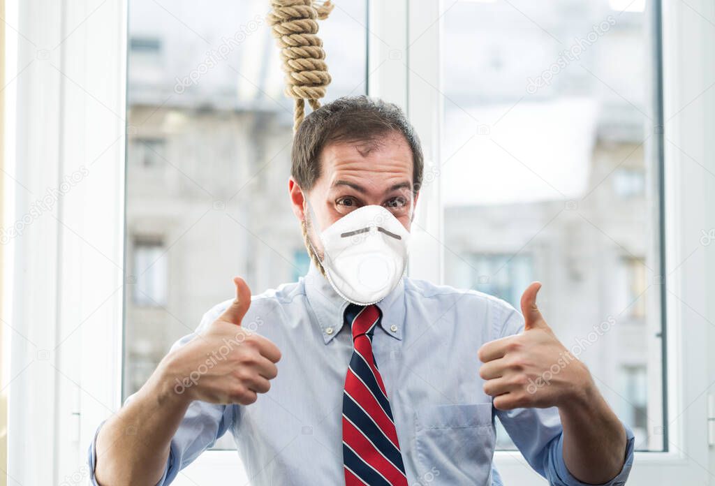 Businessman trying suicide with a rope while wearing a coronavirus mask