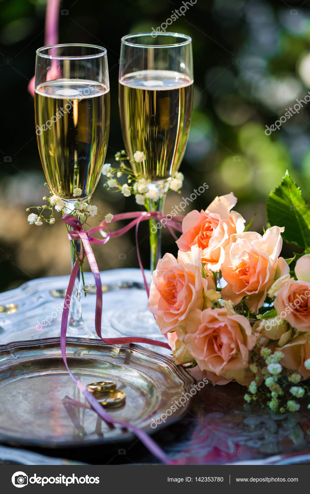 Wedding Rings Before The Ceremony With Decorated Champagne