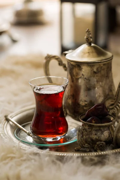 Tea set in oriental style in pear shaped glass with vintage kettle and dates fruit — Stock Photo, Image