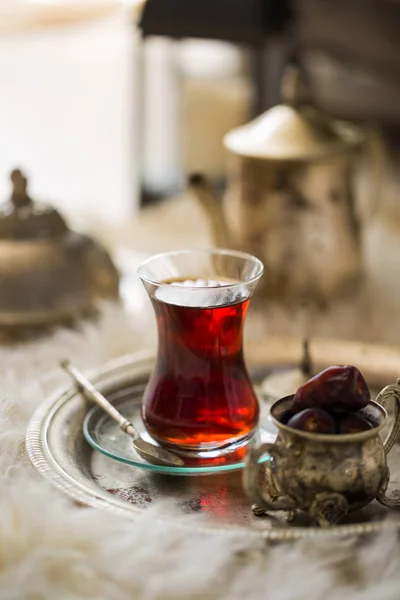 Tea set in oriental style in pear shaped glass with vintage kettle and dates fruit — Stock Photo, Image