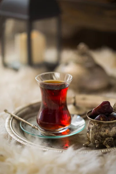 Tea set in oriental style in pear shaped glass with vintage kettle and dates fruit — Stock Photo, Image