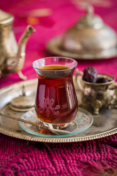 Tea set in oriental style in pear shaped glass with vintage kettle and dates fruit — Stock Photo, Image