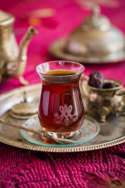 Tea set in oriental style in pear shaped glass with vintage kettle and dates fruit — Stock Photo, Image