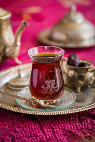 Tea set in oriental style in pear shaped glass with vintage kettle and dates fruit — Stock Photo, Image