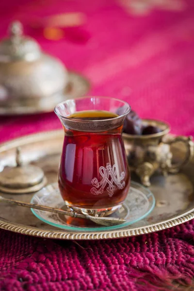 Tea set in oriental style in pear shaped glass with vintage kettle and dates fruit — Stock Photo, Image