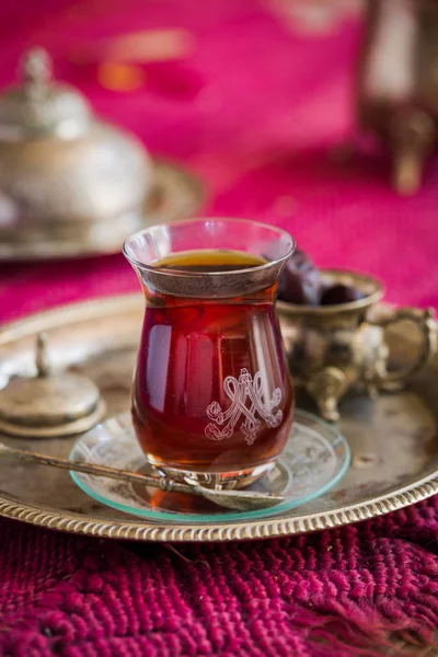 Tea set in oriental style in pear shaped glass with vintage kettle and dates fruit — Stock Photo, Image