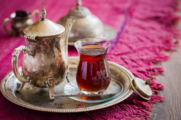 Tea set in oriental style in pear shaped glass with vintage kettle and dates fruit — Stock Photo, Image