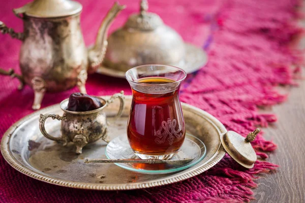 Tea set in oriental style in pear shaped glass with vintage kettle and dates fruit — Stock Photo, Image