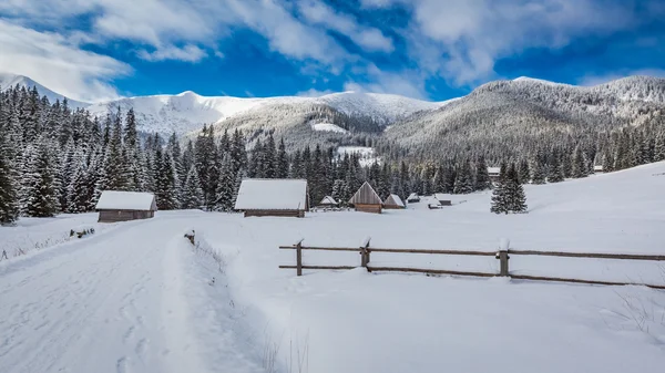 Wooden cottages covered by snow at sunrise in winter, Tatra Mountains, Poland — Stock Photo, Image