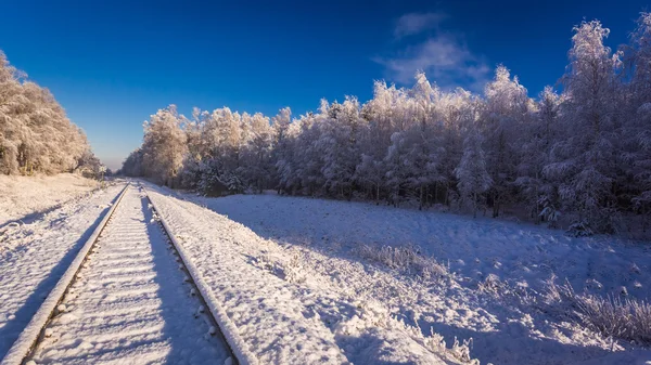 Frozen railway line in winter at sunrise — Stock Photo, Image