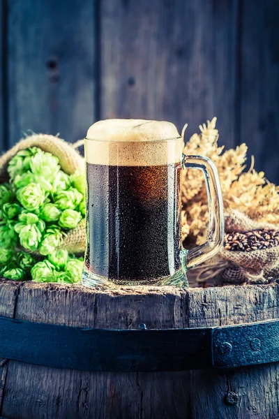 Пинта тёмного пива, пшеницы и хмеля на старую бочку — стоковое фото