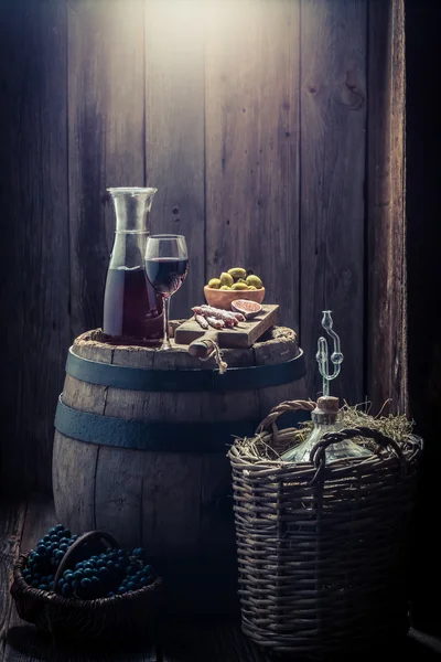 Wine in glass with olives, cold meats and grapes with copy space — Stock Photo, Image