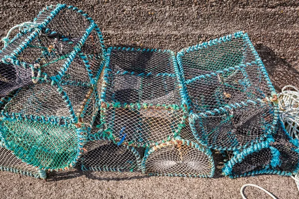 Colored fishing cage and bay with boats in Scotland — Stock Photo, Image