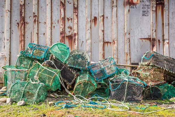 Old cage for lobster and bay with boats in Scotland — Stock Photo, Image