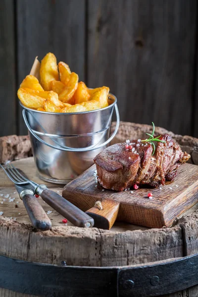 Yummy steak and chips with salt and rosemary — Stock Photo, Image