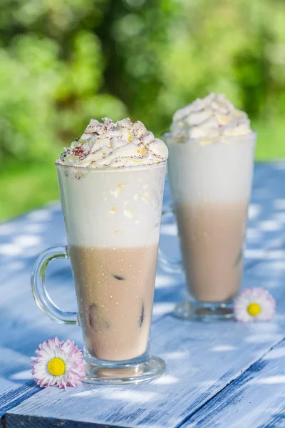 Café froid avec crème fouettée dans un jardin ensoleillé — Photo